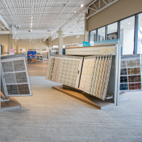 Designer carpet samples with textured neutral patterns on display.